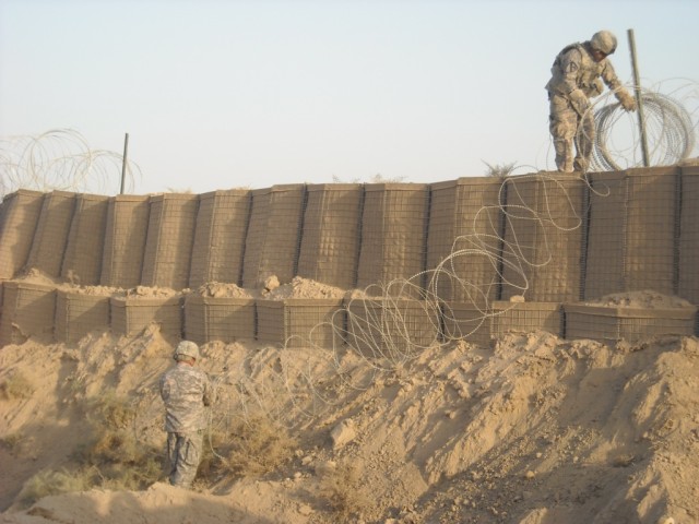 BAGHDAD- During range reconstruction at Joint Security Station Copper southeast of Baghdad in the Mahmoudya Qada, San Antonio, Texas native Sgt. Daniel Tapia (top right), heavy equipment operator, 277th Engineer Company, 46th Engineer Combat Battalio...