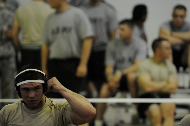 U.S. Army Sgt. Gerald Wanty, of Waupaca, Wis., attached to 3rd Battalion, 8th Cavalry Regiment, 3rd Heavy Brigade Combat Team, 1st Cavalry Division, gears up for his match during a wrestling tournament at Forward Operating Base Marez in Mosul,...