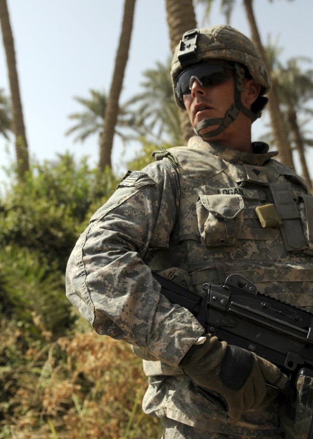 ADWANIYAH, Iraq - Spc. Brian Logan, Battery B, 1st Battalion, 113th Field Artillery Regiment, 30th Heavy Brigade Combat Team, looks back towards the other Soldiers while on a patrol in Al Buaytha, south of Baghdad, July 25. Logan, of Denton, N.C., an...