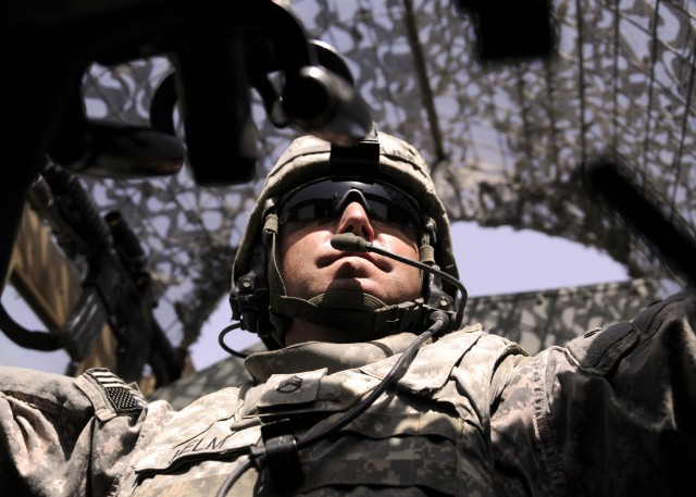 ADWANIYAH, Iraq - Staff Sgt. Richard Helm, Battery B, 1st Battalion, 113th Field Artillery Regiment, 30th Heavy Brigade Combat Team, of Kannapolis, N.C., scans the road from the gunner's hatch of his vehicle while on a patrol in Al Buaytha, south...