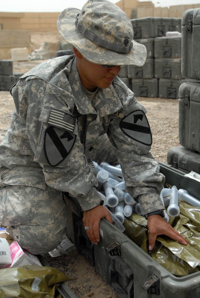 BAGHDAD - Gatesville, Texas native, Spc. Delila Jones, medic for Company C, 115th "Muleskinners" Brigade Support Battalion, 1st Brigade Combat Team, 1st Cavalry Division, packs and inventories sick call equipment, July 28, in preparation for...
