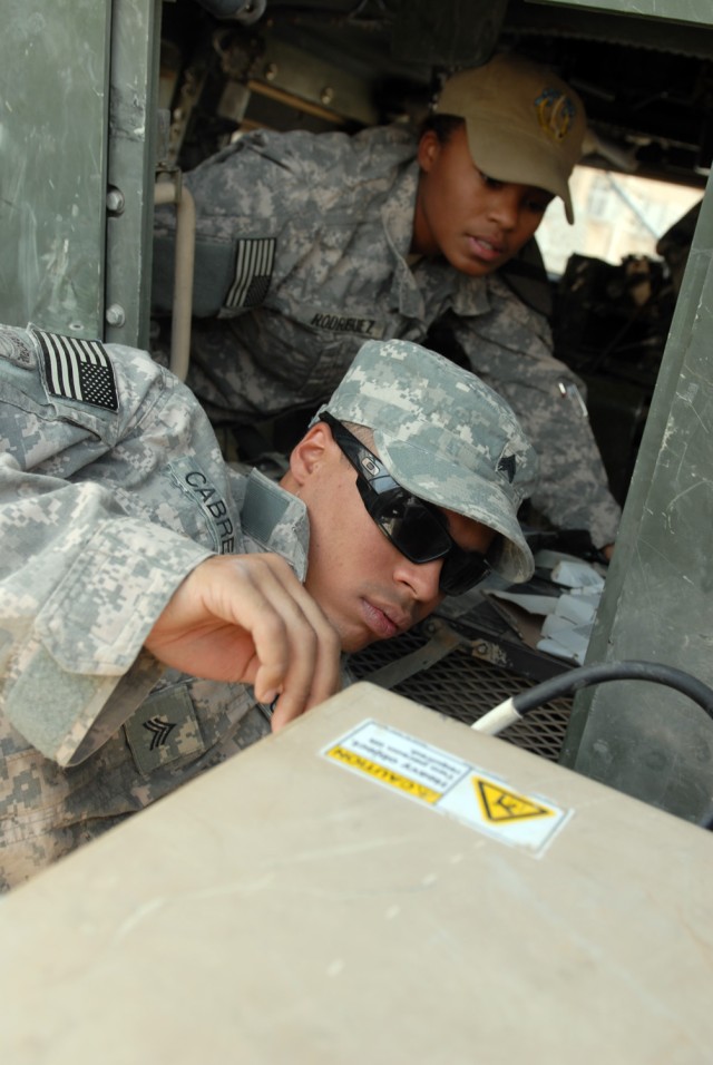 BAGHDAD - Spc. Ciara Rodriguez (background), a human intelligence collector from Harker Heights, Texas, and Sgt. Kendall Cabrera, an infantry team leader, both assigned to 1st Squadron, 7th Cavalry Regiment, 1st Brigade Combat Team, 1st Cavalry...