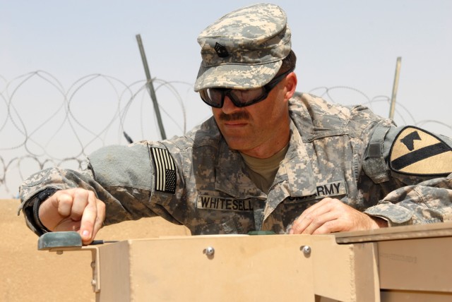 BAGHDAD - Mosier, Ore. native, 1st Sgt. Nate Whitesell, assigned to B Troop, 1st Squadron, 7th Cavalry Regiment, 1st Brigade Combat Team, 1st Cavalry Division, troubleshoots a malfunctioning counter radio-controlled improvised explosive devices...
