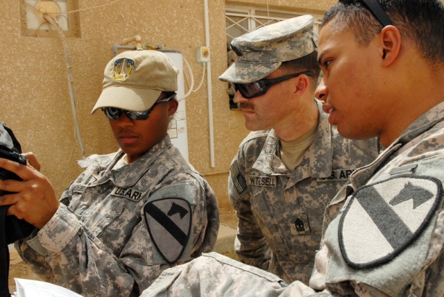 BAGHDAD - Spc. Ciara Rodriguez (left), a human intelligence collector from Harker Heights, Texas, 1st Sgt. Nate Whitesell (middle), from Mosier, Ore., and Sgt. Kendall Cabrera (right), an infantry team leader from Virginia Beach, Va., test to see...