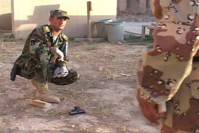 An Iraqi Police officer learns how to collect evidence and the importance of preserving fingerprints at a crime scene. U.S. military forces and State Department advisors began an Iraqi Police "train the trainer" program in July on Forward Operating B...