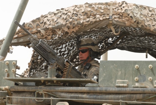 BAGHDAD - Cpl. Ed Hall, an infantryman from Julian, Pa., mans the M-249 Squad Automatic Weapon on a Stryker vehicle during a counter-improvised explosive device and counter-indirect fire mission in the Abu Ghraib area, here, July 30. Hall is...