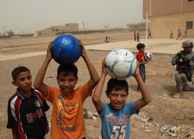 CAMP TAJI, Iraq - Schoolboys from Tarmiyah show of their new soccer balls distributed by the Iraqi Army and Iraqi Police. Soldiers with the 56th Stryker Brigade Combat Team, Multi-National Division - Baghdad helped coordinate Operation Future...