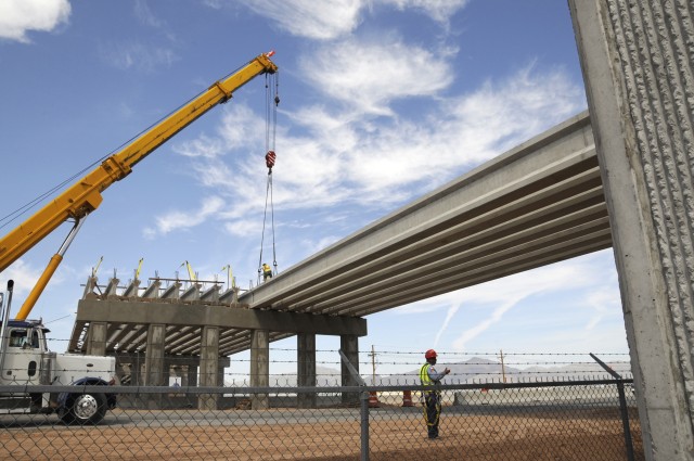 Engineers lay final bridge beams, connects expanded installation