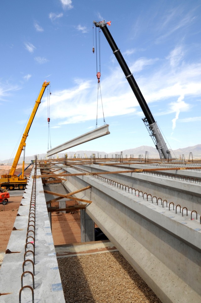 Engineers lay final bridge beams, connects expanded installation