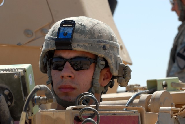 BAGHDAD - Pfc. Sam Angert, a mortar man from Brooklyn, N.Y., assigned to C Troop, 1st Squadron, 7th Cavalry Regiment, 1st Brigade Combat Team, 1st Cavalry Division, steers the M1064A3 mortar carrier into place before his fellow Soldiers fire high-exp...