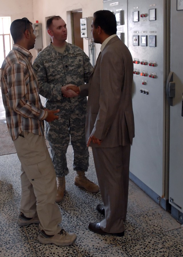 BAGHDAD - Lt. Col. Jim Bradford, a native of Lynchburg, Tenn., commander, 1st Combined Arms Battalion, 63rd Armor Regiment, 2nd Heavy Brigade Combat Team, 1st Infantry Division, Multi-National Division - Baghdad shakes the hand of Fali Ismael,...