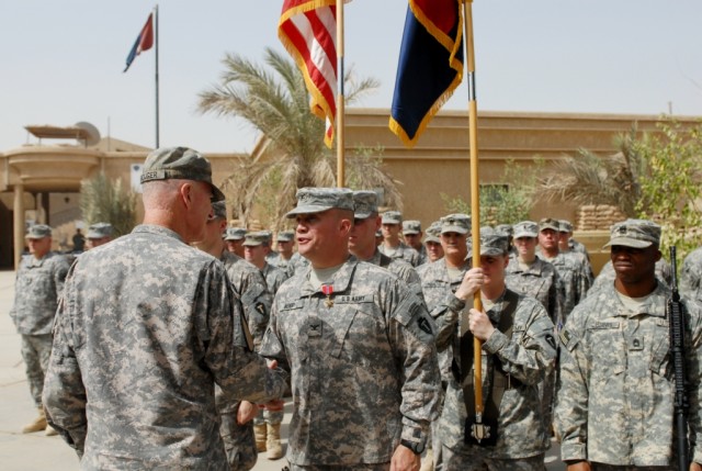 BAGHDAD – Maj. Gen. Daniel Bolger (left), commanding general, 1st Cavalry Division and Multi-National Division – Baghdad, presents Col. Lee Henry, commander, 56th Infantry Brigade Combat Team, 36th Inf. Div., with the Bronze Star Medal for Meritoriou...