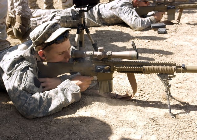 BAGHDAD - Sgt. Joseph McGowan, of Carlisle, Pa., a sniper from the 2nd Battalion, 112th Infantry Regiment "Paxton Rangers," 2nd Heavy Brigade Combat Team, 1st Infantry Division, Multi-National Division-Baghdad demonstrates marksmanship to a group...