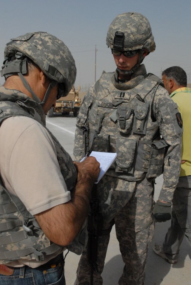 BAGHDAD - Capt. Steven Belford, Pineville, La. project manager for 225th Eng. Bde., briefs a Department of Defense contractor during the final inspection before Maya Road openes to military and Iraqi civilian traffic Aug. 1.  The one mile stretch of ...