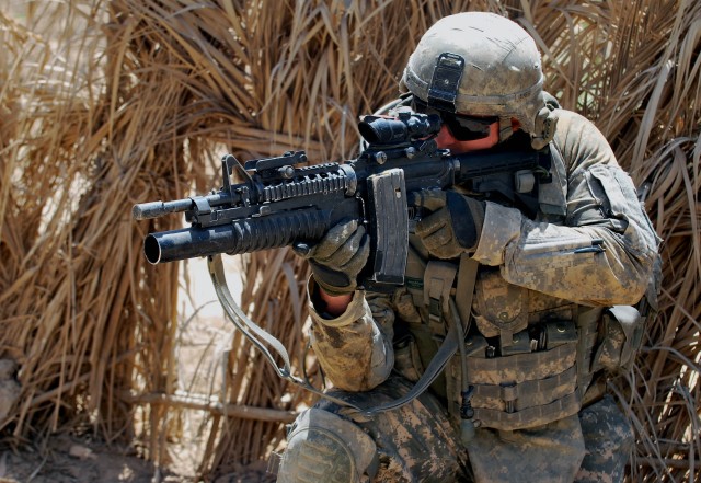 SHAKKAT, Iraq - Sgt. Daniel Holden, of Largo, Fla., uses his scope to watch for anything suspicious as he pulls security while his Iraqi Army partners search a nearby building during Operation Mufa-Ja'ah, a combined air assault mission,  July 31 in t...