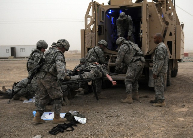 BAGHDAD - Soldiers with the 230th Brigade Support Battalion, 30th Heavy Brigade Combat Team, load a simulated casualty during a combat life saver course at Forward Operating Base Falcon, July 30. Soldiers from the battalion's Company C during...