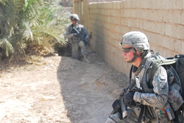 SHAKKAT, Iraq - Paratroopers assigned to Company D, 1st Battalion 505th Parachute Infantry Regiment, 3rd Brigade Combat Team, 82nd Airborne Division, Multi-National Division- Baghdad, use a concrete wall as cover as they provide support for Iraqi...