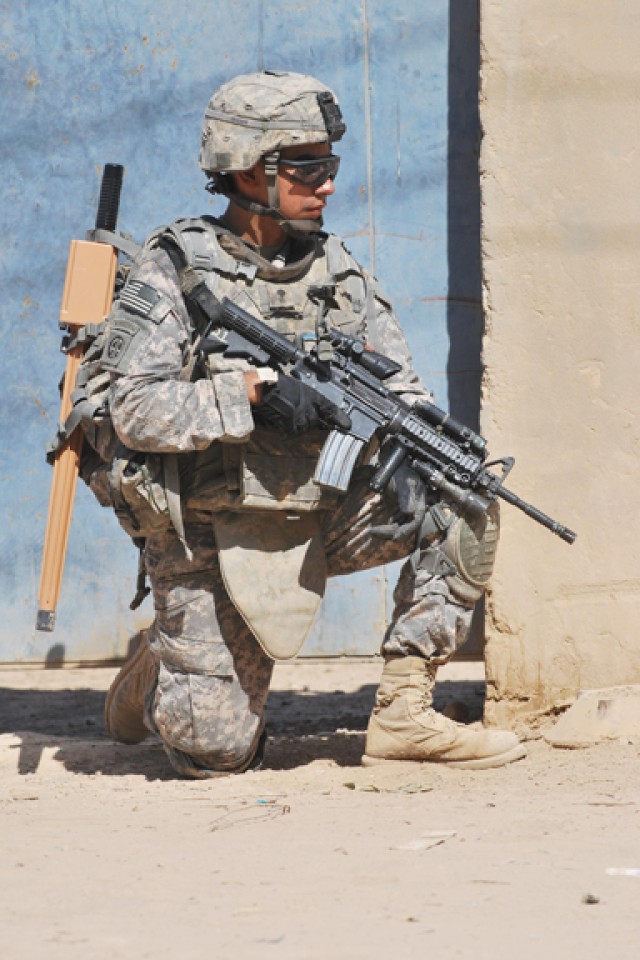 SHAKKAT, Iraq - Spc. Alejandro Garibay, of Fort Worth, Texas, scans his sector looking for anything suspicious during Operation Mufa-Ja'ah, a combined air assault mission, July 31 in the small town of Shakkat, Iraq, located in the Ma'dain region...