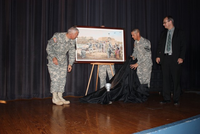 Col. Philip Battaglia, commander of the 4th Brigade Combat Team, 1st Cavalry Division, Command Sgt. Maj. Edwin Rodriguez, senior enlisted non-commissioned officer for the brigade and Mark Churms, the artist that created the painting, unveil the "Advi...
