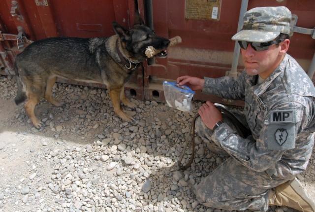 Sgt. Henry Rabs, a Mendon, Mass., native and a military working dog handler, and Capka, a military working dog, demonstrate how the dogs can sniff out narcotics during a demonstration at Forward Operating Base Warrior in Kirkuk, Iraq Aug. 1. The demo...