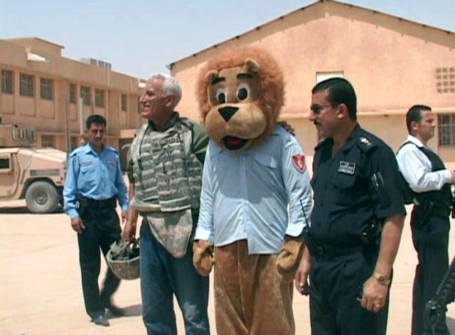 The "Lion of Kirkuk", the mascot of the Iraqi Police in Kirkuk, Iraq, visited children during a humanitarian aid delivery with the Aruba sub-district police station police, July 27. The IP, with assistance from the U.S. Army, delivered food, toys, an...