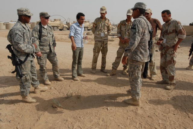 Iraqi Army soldiers and instructors from 1st Battalion, 8th Cavalry Regiment, 2nd Brigade Combat Team, 1st Cavalry Division, inspect a mound of dirt that contains a hoax Improvised Explosive Device on Forward Operating Base McHenry, Iraq, July 22....