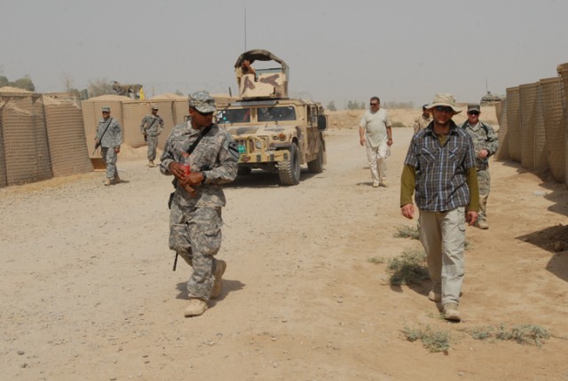 Sgt Kervin Catillo, a Copperas Cove, Texas, native and a combat engineer with Company E, 1st Battalion, 8th Cavalry Regiment, 2nd Brigade Combat Team, 1st Cavalry Division, leads an Iraqi Army military vehicle through an Improvised Explosive...
