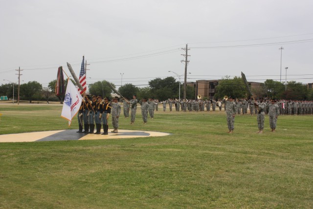 Soldiers of the 4th Brigade Combat Team, 1st Cavalry Division, render a salute to the national colors during the 2nd Battalion, 7th Cavalry Regiment and 2nd Battalion, 12th Cavalry Regiment's Change of Command Ceremony on Fort Hood's Cooper Field, Ju...