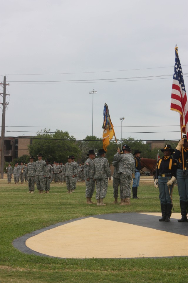 Command Sgt. Maj. George Zamudio, senior enlisted leader assigned to the 2nd Battalion, 7th Cavalry Regiment, passes the battalion's guidon to Lt. Col. Edward Bohnemann, the unit's outgoing commander, during the 2nd Battalion, 7th Cavalry Regiment an...