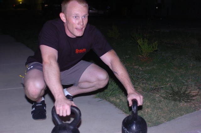 Capt. Michael Keathley, from Leesville, La., assigned to Headquarter and Headquarter Company, 4th Brigade Combat Team, 1st Cavalry Division, complete a 100-yard kettle bell sprint workout as a part of his CrossFit workout regime, July 23, in...