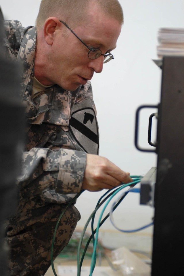 CAMP TAJI, Iraq - Colombia, Tenn. native Spc. James Owen, an information technology specialist for 1st Brigade Combat Team, 1st Cavalry Division, tests the network in preparation for the set up of the new brigade Tactical Command Post, here, Aug...