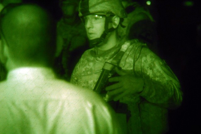 BAGHDAD - A platoon leader, 1st Lt. Mike Olvera, assigned to 1st Squadron, 7th Cavalry Regiment, 1st Brigade Combat Team, 1st Cavalry Division, talks to Iraqi shop owners to assess if they qualify for a micro-grant during a night patrol of Subak Sur,...