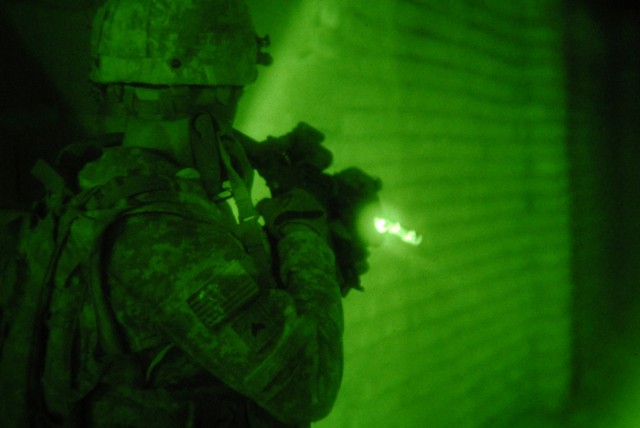 BAGHDAD - In order to clear an abandoned building, Cpl. Ivan Ibabao a cavalry scout, assigned to 1st Squadron, 7th Cavalry Regiment, 1st Brigade Combat Team, 1st Cavalry Division, quickly turns on his flashlight and scans the area for enemy activity ...
