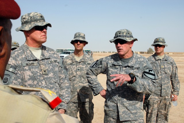 BAGHDAD - Brig. Gen. John Murray (gesturing), deputy commanding general for maneuver, 1st Cavalry Division, Multi-National Division-Baghdad, talks with Iraqi Army Gen. Abud Kanbar Hashim, commander of Baghdad Operational Command, during a visit to ob...