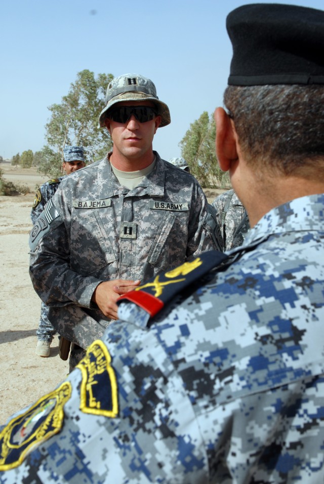 BAGHDAD - Capt. Nicholas Bajema, of Seattle, listens to a question from Iraqi National Police Maj. Gen. Abd al-Karim, commander of Rusafa Area Command, during a tour of the training the Iraqi Army and National Police are receiving at Forward Operatin...
