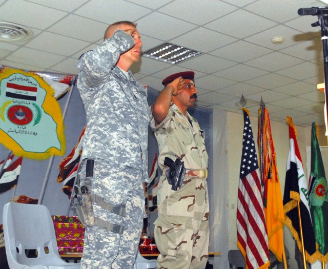 Command Sgt. Maj. Jeffery Hof (left) and Command Sgt. Maj. Waleed Ibrahim Ismael, the top enlisted Soldiers from the 2nd Brigade Combat Team, 1st Cavalry Division, and 12th Iraqi Army Division, respectively, salute during the playing of the U.S. and ...