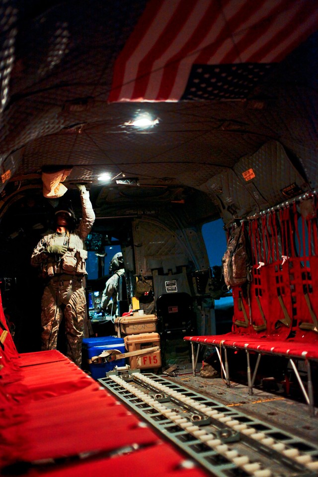 CAMP TAJI, Iraq-During the aircraft run-up, Pfc. Kelvio Gomes, from Chicago, a CH-47F Chinook helicopter door gunner in Company B, 2nd Battalion, 227th Aviation Regiment, 1st Air Cavalry Brigade, 1st Cavalry Division, Multi-National Division -...