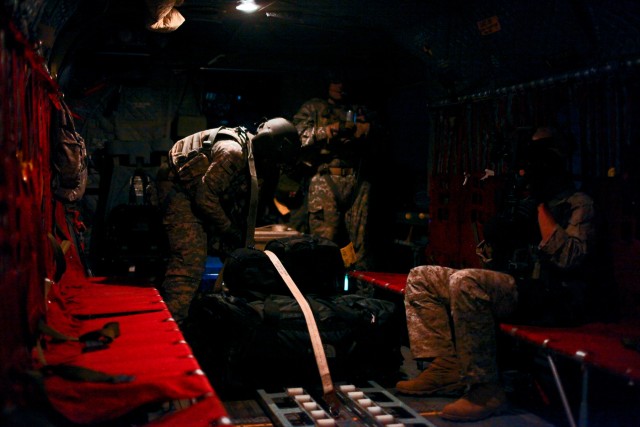 CAMP TAJI, Iraq-Once cargo is loaded, Pfc. Kelvio Gomes, from Chicago, a CH-47F Chinook helicopter door gunner in Company B, 2nd Battalion, 227th Aviation Regiment, 1st Air Cavalry Brigade, 1st Cavalry Division, Multi-National Division - Baghdad,...