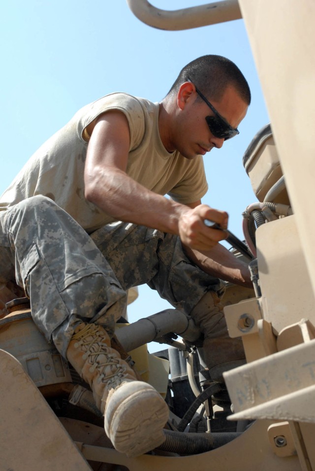 BAGHDAD - Houston, Texas native, Spc. Michael Saucier, a Bradley mechanic for A Company, 2nd Battalion, 5th Cavalry Regiment, 1st Brigade Combat Team, 1st Cavalry Division, checks and replaces the air filter on a Mine Resistant Ambush Protected vehic...