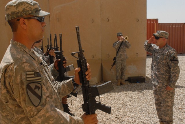 Soldiers execute a 21-gun salute in honor of Sgt. 1st Class Johnny Polk at a memorial service on Forward Operating Base Warrior, Kirkuk, Iraq, August 8. Polk served as an artilleryman and died July 31 from wounds sustained from a grenade attack in...