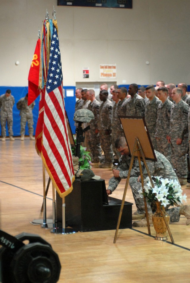 1st Lt. Jaciel Guerrero, a platoon leader with Headquarters and Headquarters Battery, 3rd Battalion, 82nd Field Artillery Regiment, 2nd Brigade Combat Team, 1st Cavalry Division, bows his head in memory of Sgt. 1st Class Johnny Polk during a...