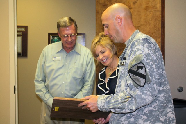 Lt. Col. Tim Norton, former Commander of the 4th Brigade Special Troops Battalion, 4th Brigade Combat Team, 1st Cavalry Division, presents Bill and Jean Shine, representatives from the Shine Team Realtor's Company, with a plaque of appreciation...
