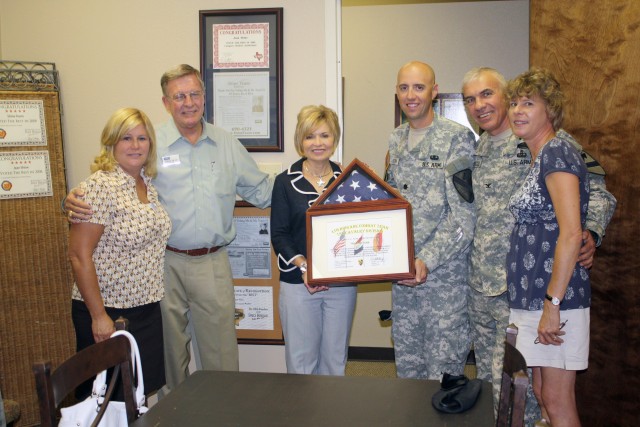Col. Philip Battaglia, former Commander of the 4th Brigade Combat Team, 1st Cavalry Division, Lt. Col. Tim Norton, former Commander of the 4th Brigade Special Troops Battalion along with their wives Diane Battaglia and Leslie Norton, present Bill...