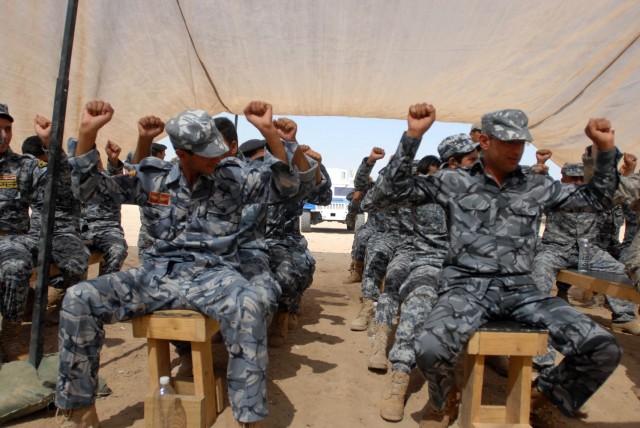 BAGHDAD - Federal Policemen, from the 1st and 2nd Battalions, 2nd Federal Police Brigade, "brace" themselves during a rollover drill at Joint Security Station Istiqlaal Aug. 12.  Soldiers from Troop C, 1st "Garryowen" Squadron, 7th Cavalry...
