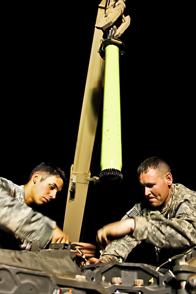 CAMP TAJI, Iraq-Spc. Christian Pino (left), from San Diego, and Spc. Josh Ramsey, from Pomona, Miss., both AH-64D Apache attack helicopter crew chiefs in 1st Battalion, 227th Aviation Regiment, 1st Air Cavalry Brigade, 1st Cavalry Division, Multi-Nat...