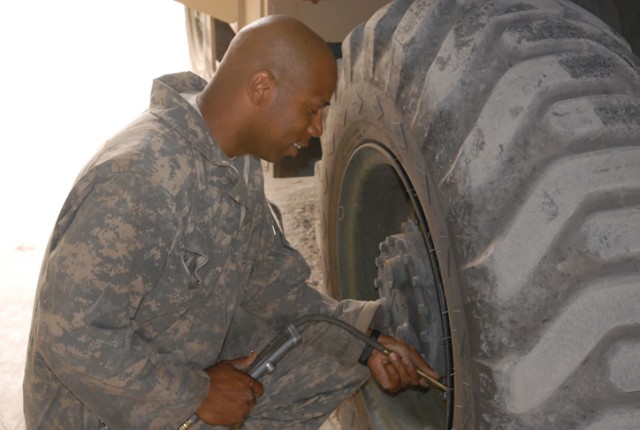 Pfc. Emory Ramey, a Rome, Ga., native and quartermaster chemical repair specialist with 15th Brigade Support Battalion, 2nd Brigade Combat Team, 1st Cavalry Division, refills the tire on a forklift in the ground support equipment section shop on...