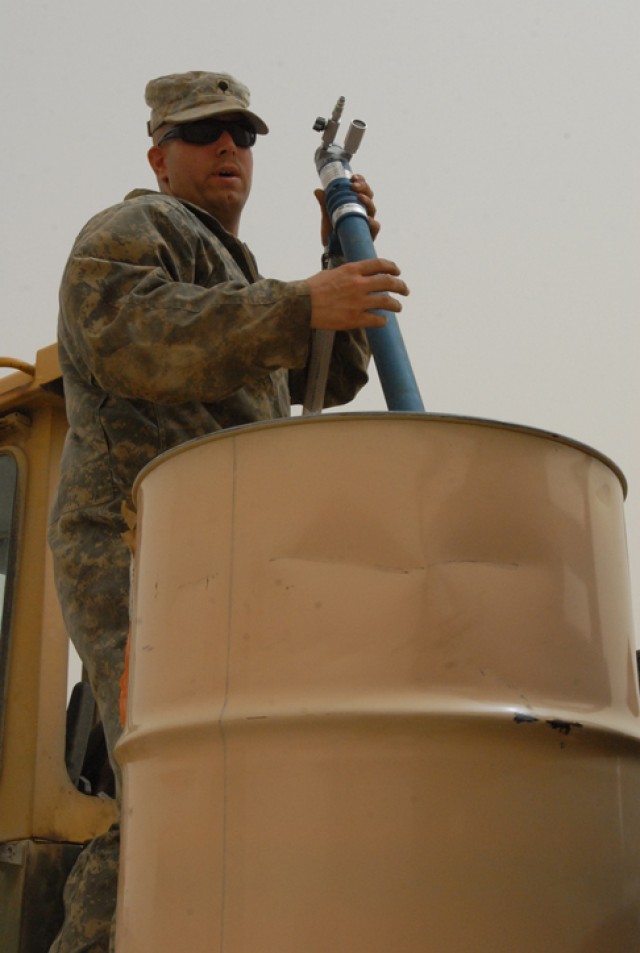 Spc. Joe McGovern, a Gaylord, Mich., native and a quartermaster chemical repair specialist with the ground support equipment section shop with 15th Brigade Support Battalion, 2nd Brigade Combat Team, 1st Cavalry Division, takes hydraulic fluid...