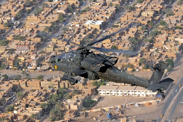 CAMP TAJI, Iraq-An AH-64D Apache attack helicopter from Company B, 1st Battalion, 227th Aviation Regiment, 1st Air Cavalry Brigade, 1st Cavalry Division, Multi-National Division - Baghdad, flys over Baghdad; providing security for U.S. ground...