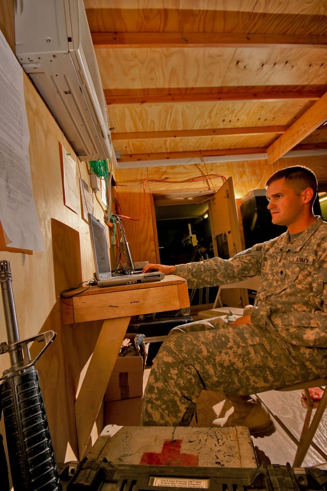 CAMP TAJI, Iraq-Working on a computer provided by his chain of command, Spc. John Harmon, from Clayton, Ga., an aircraft structual repair specialist in Company D, 4th Battalion, 227th Aviation Regiment, 1st Air Cavalry Brigade, 1st Cavalry...
