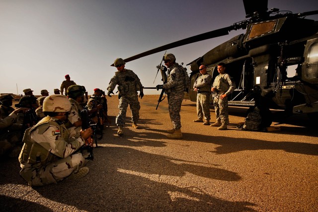 CAMP TAJI, Iraq-Giving a brief to Iraqi Soldiers, Maj. Jim Tenpenny (center and pointing), from Platte City, Mo., the operations officer in charge for 3rd Battalion, 227th Aviation Regiment, 1st Air Cavalry Brigade, 1st Cavalry Division,...